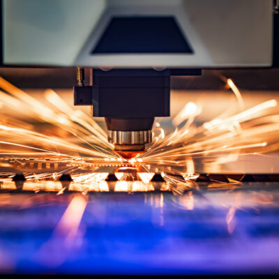 CNC Laser cutting of metal, modern industrial technology. Small depth of field. Warning - authentic shooting in challenging conditions.